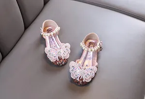 Top view of pink girl's princess shoes featuring sparkling rhinestones and butterfly detail