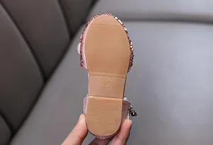 Detail of pink glitter princess shoe sole with size 26 marking and anti-slip texture