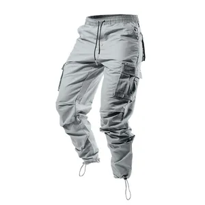 Detailed view of men's grey multi-pocket cargo pants featuring elastic drawstring waist.