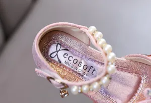 Detailed view of pink girls princess shoe featuring elegant pearl trim and sparkly finish