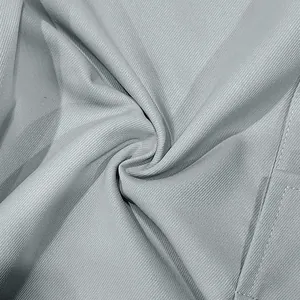 Detailed close-up of the grey twill fabric and stitching on men's cargo trousers.