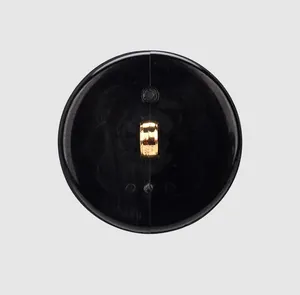 Detailed back view showing the gold shank of a premium round black nylon button.