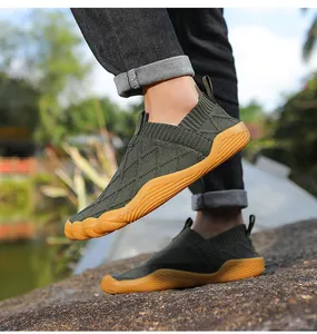 Lightweight barefoot hiking shoes with breathable green knit upper and orange sole