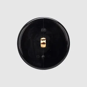 Close-up back view of a premium black circular shank button with gold metal loop shank