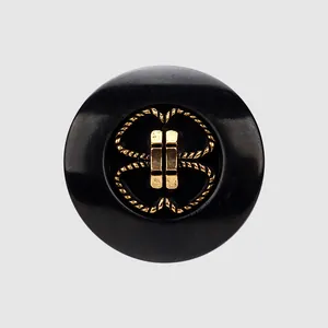 High-end black plant fiber button with golden metal knot detail for luxury apparel.