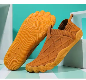Detailed view of the grooved anti-slip sole and fly-knit upper of the barefoot hiking shoe