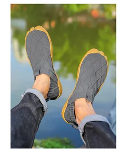 Lightweight gray fly-knit wide toe barefoot shoes for men shown in outdoor park setting