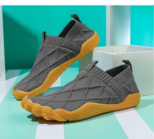 Detail view of lightweight wide toe grey flyknit barefoot shoes with yellow gum sole