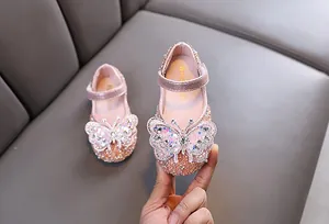 Detailed view of pink girls' princess shoes with sparkling butterfly rhinestones