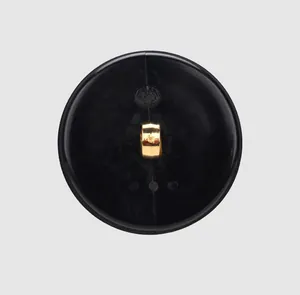 Close-up detail of the back side of a premium black nylon shank button with gold loop