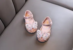 Detailed view of pink princess shoes for girls with sparkling rhinestone butterfly