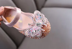 Detailed view of pink princess shoes for girls with rhinestones and butterfly deco