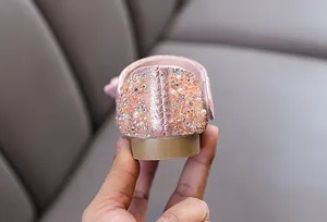 Detail view of pink rhinestone and pearl embellishments on kids princess shoe heel
