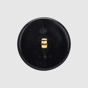 High-quality black nylon button with a luxurious gold metal shank for premium apparel