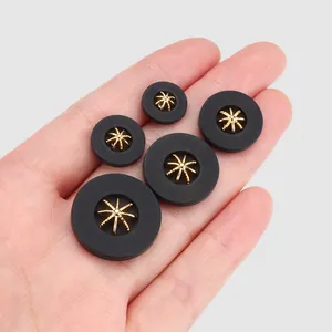 Elegant black plant fiber nylon buttons with gold star inlay in five various sizes on hand