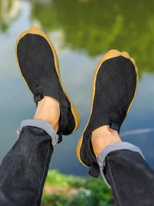 Lightweight wide-toe knit barefoot hiking shoes for men in natural outdoor setting