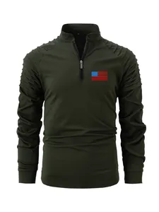 Detail view of olive green men's long sleeve polo shirt with pleated sleeves and flag logo.