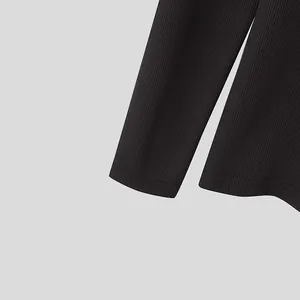 Detailed close-up of black ribbed knit texture on men's long sleeve base layer shirt