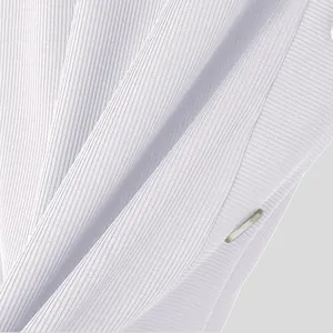 Close-up view of premium white ribbed knit fabric texture with metal button detail.
