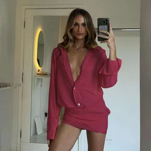 Dettaglio dell'abito fucsia con scollo a V profondo e gonna a portafoglio ruche.