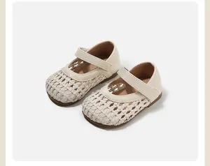Close-up of beige toddler girl's woven hollow-out Mary Jane princess walking shoes.