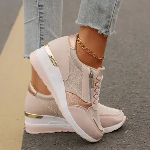 Detailed view of women's pink platform sneakers featuring a stylish side zipper design.