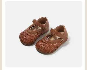 Detail of brown woven hollowed-out princess shoes for baby girls' first steps.
