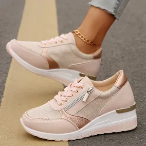 Detail of pink platform sneakers featuring a side zipper and breathable mesh upper.