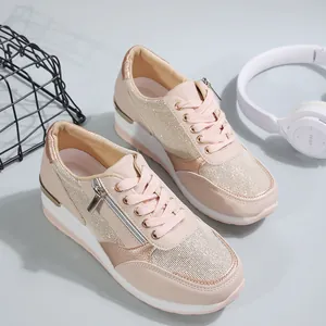Detailed view of comfortable pink wedge sneakers with side zipper and metallic accents