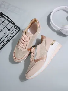 Top view of stylish pink platform sneakers for women with side zippers and lifestyle props