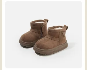 Detailed view of brown toddler snow boots with warm plush lining and side zippers.