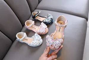 Detail of pink girl's princess shoes with sparkling rhinestones and butterfly ornament