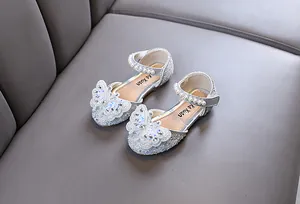 Detail showing sparkling silver toddler flats with rhinestone butterfly and pearl strap