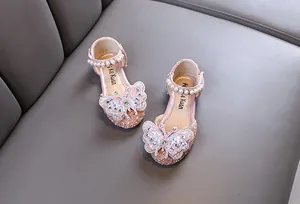 Close-up of sparkling girl's princess shoes with rhinestone butterfly decoration