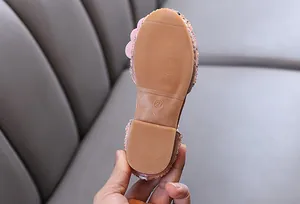 Close-up of anti-slip rubber sole for girls rhinestone embellished princess dance shoes.