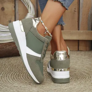 Close-up of stylish women's olive green wedge sneakers featuring gold metallic accents.
