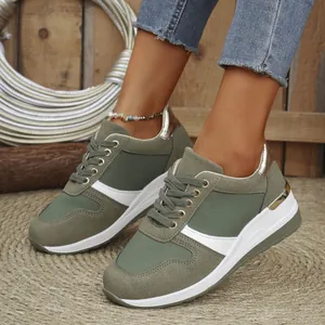 Detailed view of olive green wedge sneakers with gold accents and platform sole