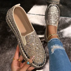 Detailed macro view of sparkly sequin loafers with thick soles and braided edges