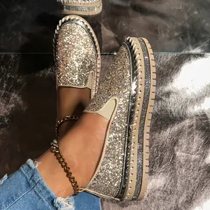 Detailed shot of sparkling champagne glitter platform slip-on shoes with rhinestones