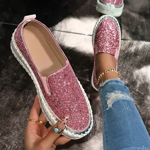 Close-up of pink glitter platform loafers featuring sparkling rhinestone edge detailing