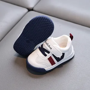 White leather baby walking shoes for toddlers with non-slip soft soles and velcro straps