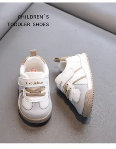 Stylish white and grey toddler sneakers with soft soles and velcro straps