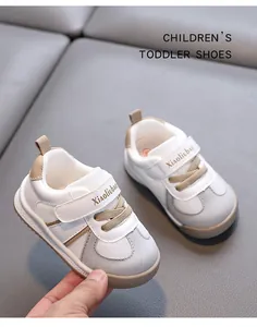 Detailed view of children's walking shoes with soft soles and white leather mesh