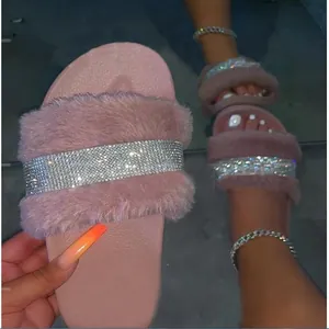 Detail of pink rhinestone fuzzy slipper showing the soft fur and sparkly strap.