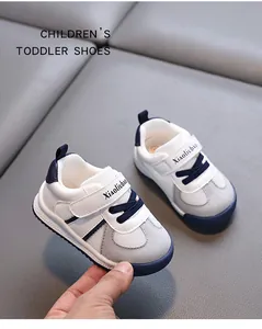 Detail shot of white and grey children's toddler sports shoes with blue velcro straps