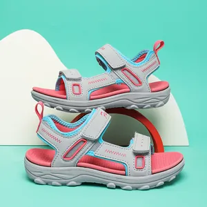 Detailed side view of stylish girls non-slip lightweight beach sandals in grey and pink.