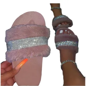 Chic pink furry slides for women with sparkly rhinestone strap and comfortable flat sole.
