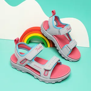 Close-up view of children's grey and pink sports sandals with adjustable Velcro straps.