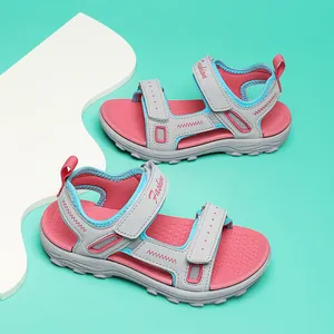 Detailed view of stylish grey and pink girls sandals featuring adjustable velcro straps