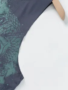 Macro view of the green skull print and fabric texture on a dark grey sleeveless top